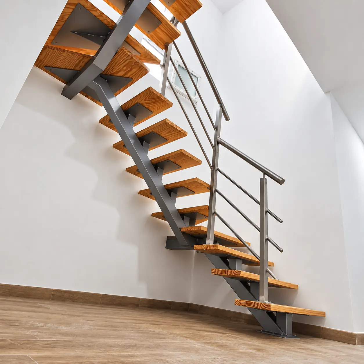 Escalera de madera y estructura metálica central con barandilla recta
